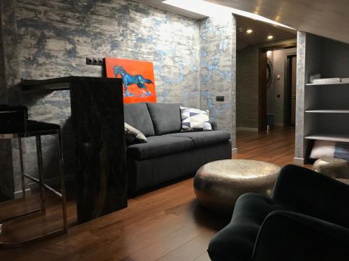 a living room with a couch and a table at ArtApart Vozdvigenka in Kyiv