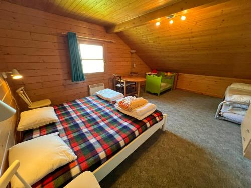 a bedroom with a bed in a wooden cabin at Amandi in Hotton