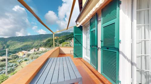 a balcony of a house with green shutters at Ca' dell'aia - By Ligooria in Magliolo