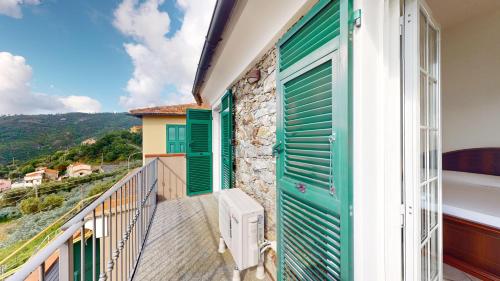 a balcony of a house with green shutters at Ca' dell'aia - By Ligooria in Magliolo