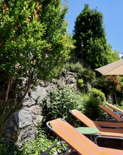 a group of chairs and a table and an umbrella at Haus Marianne in Millstatt