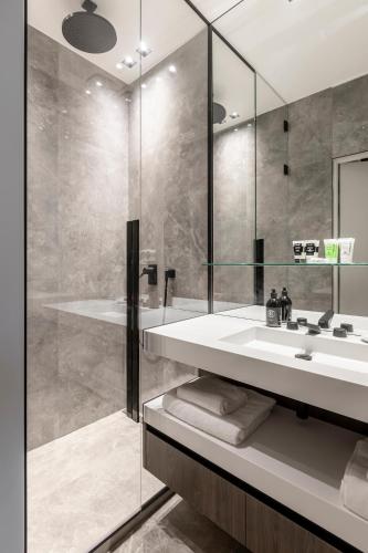 a bathroom with a sink and a shower at Maison Boissière BARNES Residences in Paris