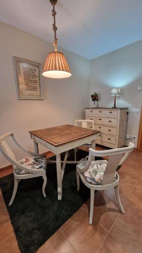 a dining room with a table and two chairs at Vivienda de uso turistico Altora in Tomelloso