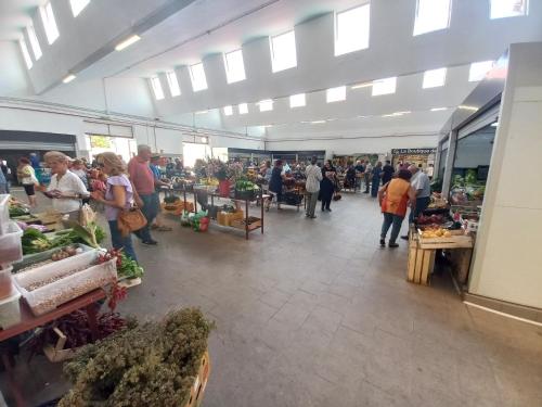 a group of people walking around a farmers market at Casa degli Ulivi in Ortona