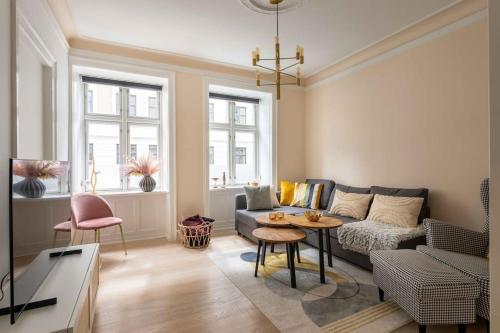 a living room with a couch and a table at City Central 2BR Apartment Next to the Lakes in Copenhagen