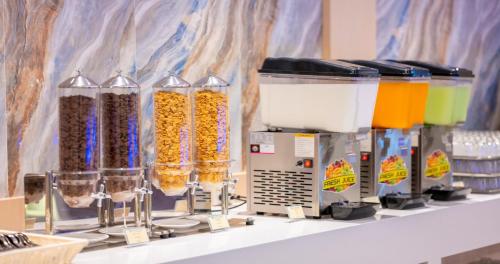 a row of containers of food on a shelf at Wyndham Jomtien Pattaya in Na Jomtien
