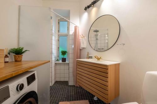 a bathroom with a sink and a mirror at City Central 2BR Apartment Next to the Lakes in Copenhagen