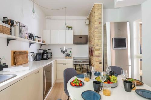 a kitchen with a table with fruit on it at City Central 2BR Apartment Next to the Lakes in Copenhagen