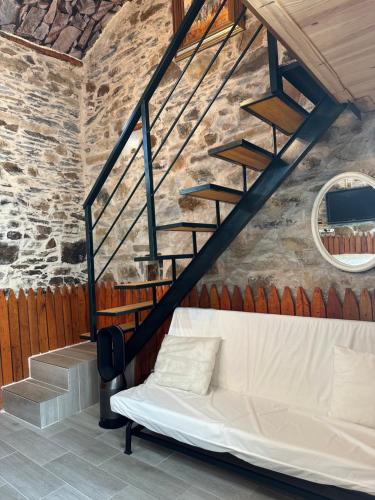 a white couch in a room with a staircase at Casa Curillas in Curillas
