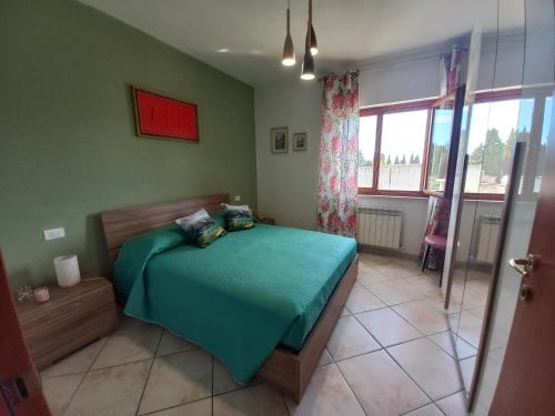a bedroom with a bed in a room with a window at Casa degli Ulivi in Ortona