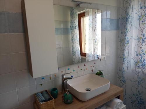 a bathroom with a sink and a mirror at Casa degli Ulivi in Ortona
