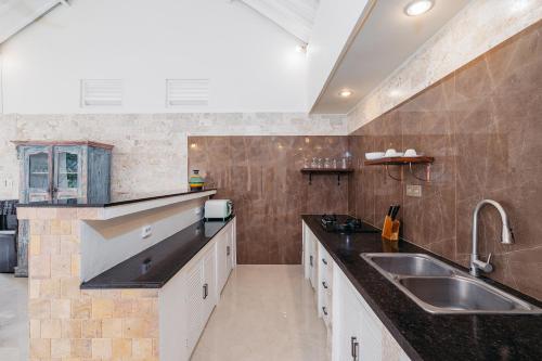 a kitchen with a sink and a counter top at Green Garden Seminyak Villa in Seminyak