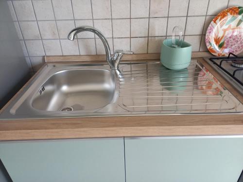 a kitchen sink with a faucet on a counter at Casa degli Ulivi in Ortona
