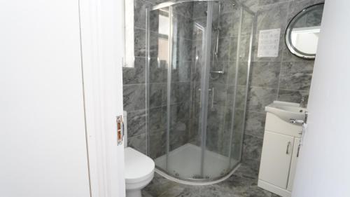 a bathroom with a shower and a toilet at 59B Comfortable 3 Bedroom House By Easy 2 Manage in Cranford
