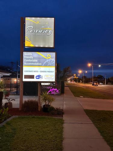 a sign for a dealership on the side of a street at Pevensey Motor Lodge in Echuca