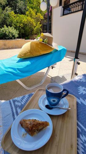a plate of food and a cup of coffee on a table at Villa Penelope Luxury Retreat with Pool & Timeless Charm in Douliana