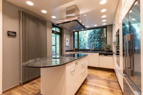 a kitchen with a large island with a counter top at Villa Francine in Deinze