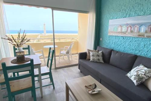 a living room with a couch and a table at Starfish Home, AWESOME VIEWS, FREE WIFI & NETFLIX in Morro del Jable