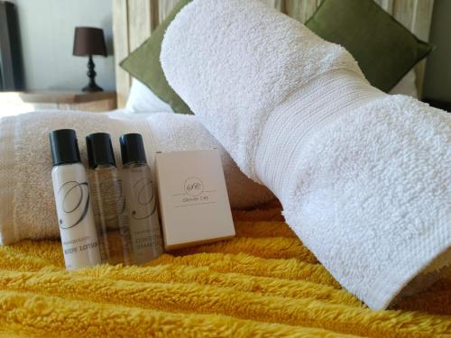 a group of three products on a bed with a towel at Picanha Guesthouse in Heidelberg