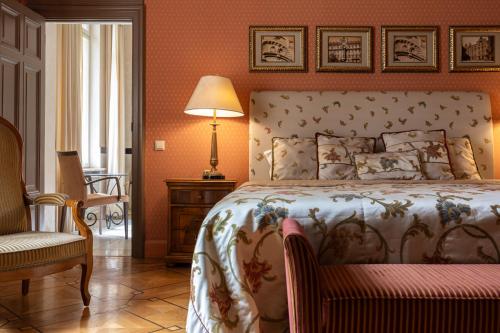 a bedroom with a bed and a chair and a lamp at The Benjamin House in Rīga