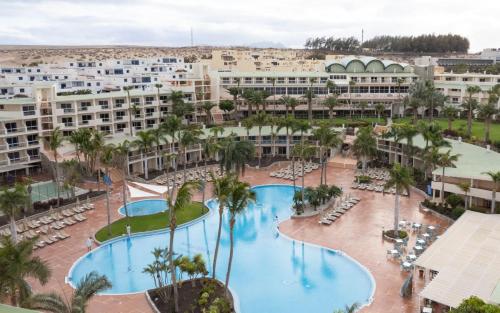 an aerial view of a resort with two pools and palm trees at Club Hotel Drago Park in Costa Calma
