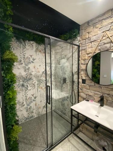 a bathroom with a glass shower and a sink at Apartmán Rysy in Tatranska Strba