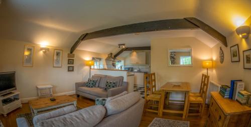 a living room with a couch and a table at Heathy Lea Barn Chatsworth Estate in Baslow