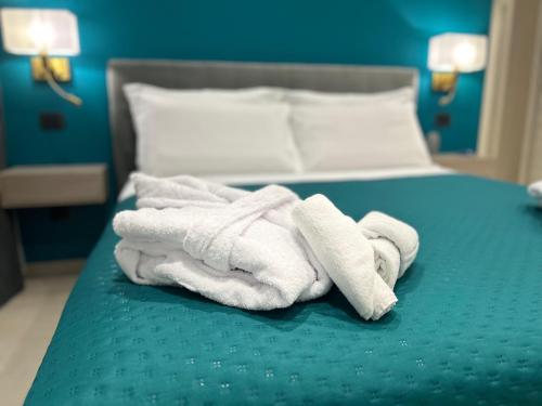 a pile of towels sitting on top of a bed at Lakes and Mountains Magic Holiday House in Omegna