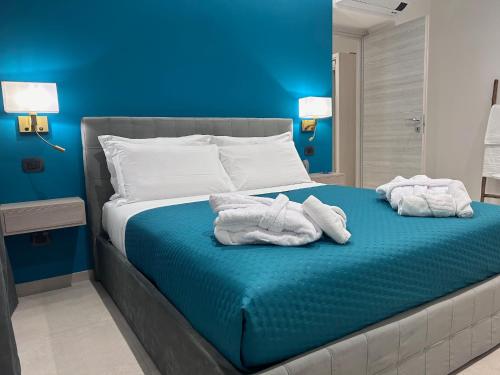 a bedroom with a bed with towels on it at Lakes and Mountains Magic Holiday House in Omegna