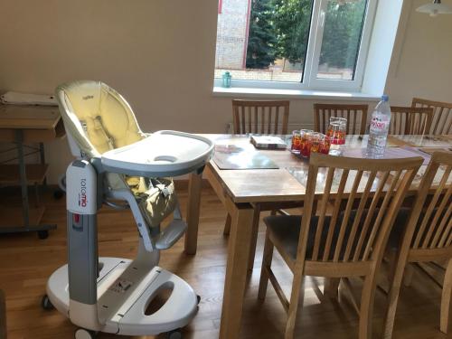 a high chair sitting next to a dining room table at House on the sea side in Ragaciems