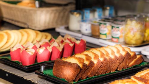 a table with two trays of bread and other foods at Hôtel Du Bois Champs-Elysées in Paris