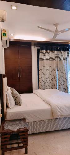 a bedroom with a large bed and a window at Hostmystay- 3bhk apartment!Greater kailash 1 in New Delhi