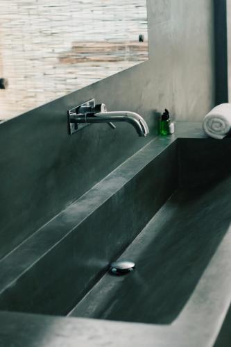 a black sink with a faucet on a counter at Private Pool Cabanas AC - Angam Villas Hikkaduwa in Hikkaduwa