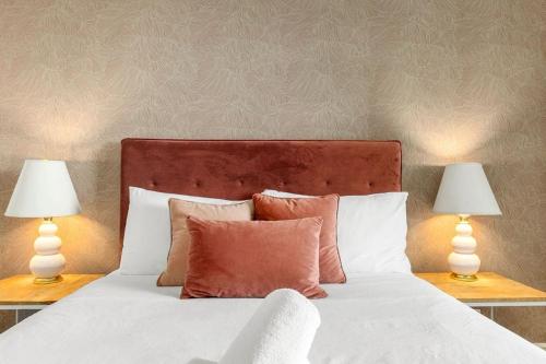a bedroom with a bed with two lamps on tables at Holiday Home by Barangaroo Reserve in Sydney