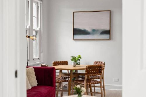 a living room with a table and chairs at Holiday Home by Barangaroo Reserve in Sydney