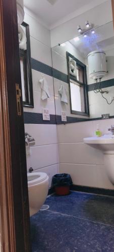 a bathroom with a toilet and a sink at Hostmystay- 3bhk apartment!Greater kailash 1 in New Delhi