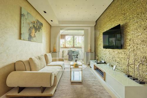 a living room with a couch and a tv at Junior by Kristal Collection in Bucharest
