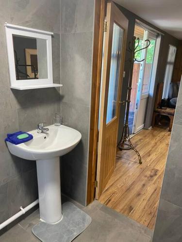 a bathroom with a sink and a mirror at Bar Lodge in Ilkeston