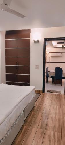 a bedroom with a large bed and a table at Hostmystay- 3bhk apartment!Greater kailash 1 in New Delhi