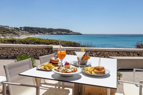 a table with food on it with a view of the ocean at Seth Santo Tomás in Santo Tomás