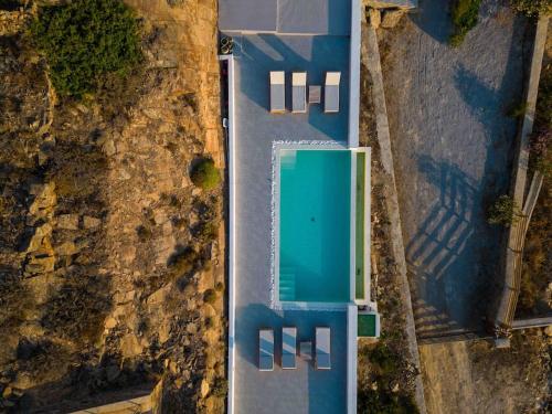 an overhead view of a parking lot with a green garage at Thalassa in Ios Chora