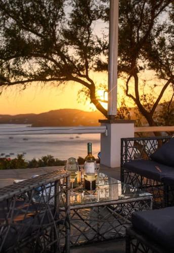 a table with two bottles of wine on top of it at Thalassa in Ios Chora