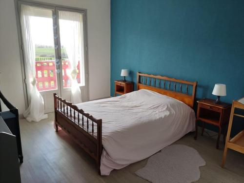 a bedroom with a large bed and a window at Superbe appartement avec vue sur le Puy de Dôme in Saint-Georges-de-Mons
