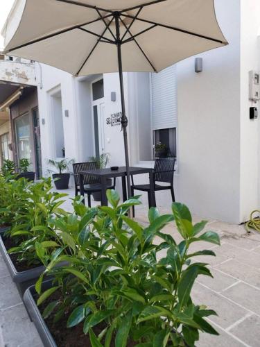 a patio with a table and an umbrella at Casa d'oro 56 Living in Paradisi Rhodes in Paradeísion