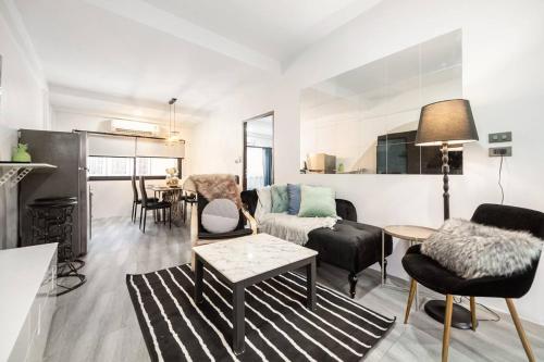 a living room with a couch and a table at Spacious 4BR Family Chatuchak Market 12 sleeps in Bangkok
