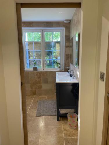 a bathroom with a sink and a window at Maison de la petite sorcière in Razac-de-Saussignac