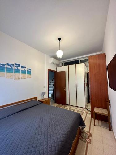 a bedroom with a blue bed and a cabinet at Alloggio Vacanze Caieta in Gaeta