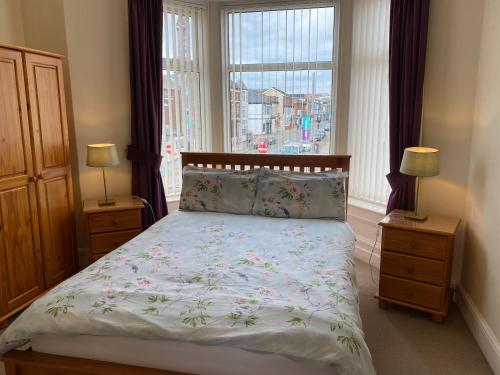 a bedroom with a bed and a large window at The Laurels in Blackpool