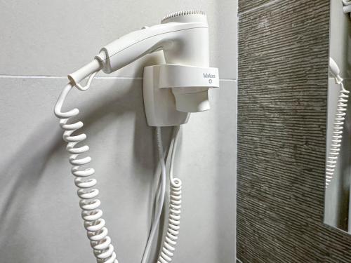 a landline phone is hanging on a wall at ACM Premium 3 camere Apartament elegant in Voluntari