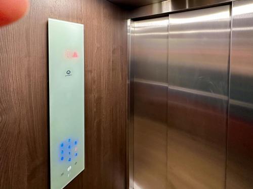 a elevator with a metal door with blue buttons at ACM Premium 3 camere Apartament elegant in Voluntari